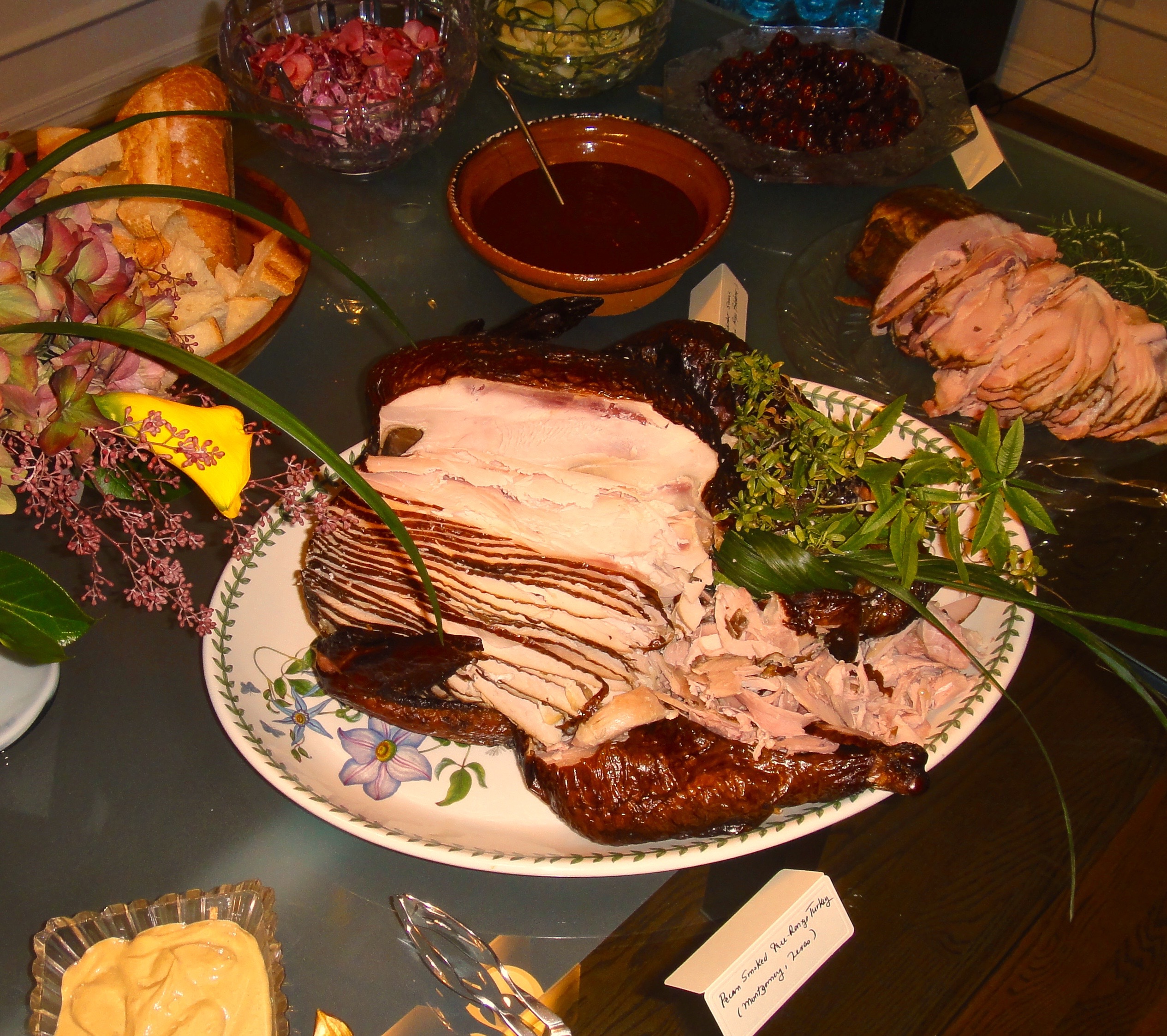 Sliced smoked turkey for Thanksgiving served with a Chile Ancho Adobo (bowl)