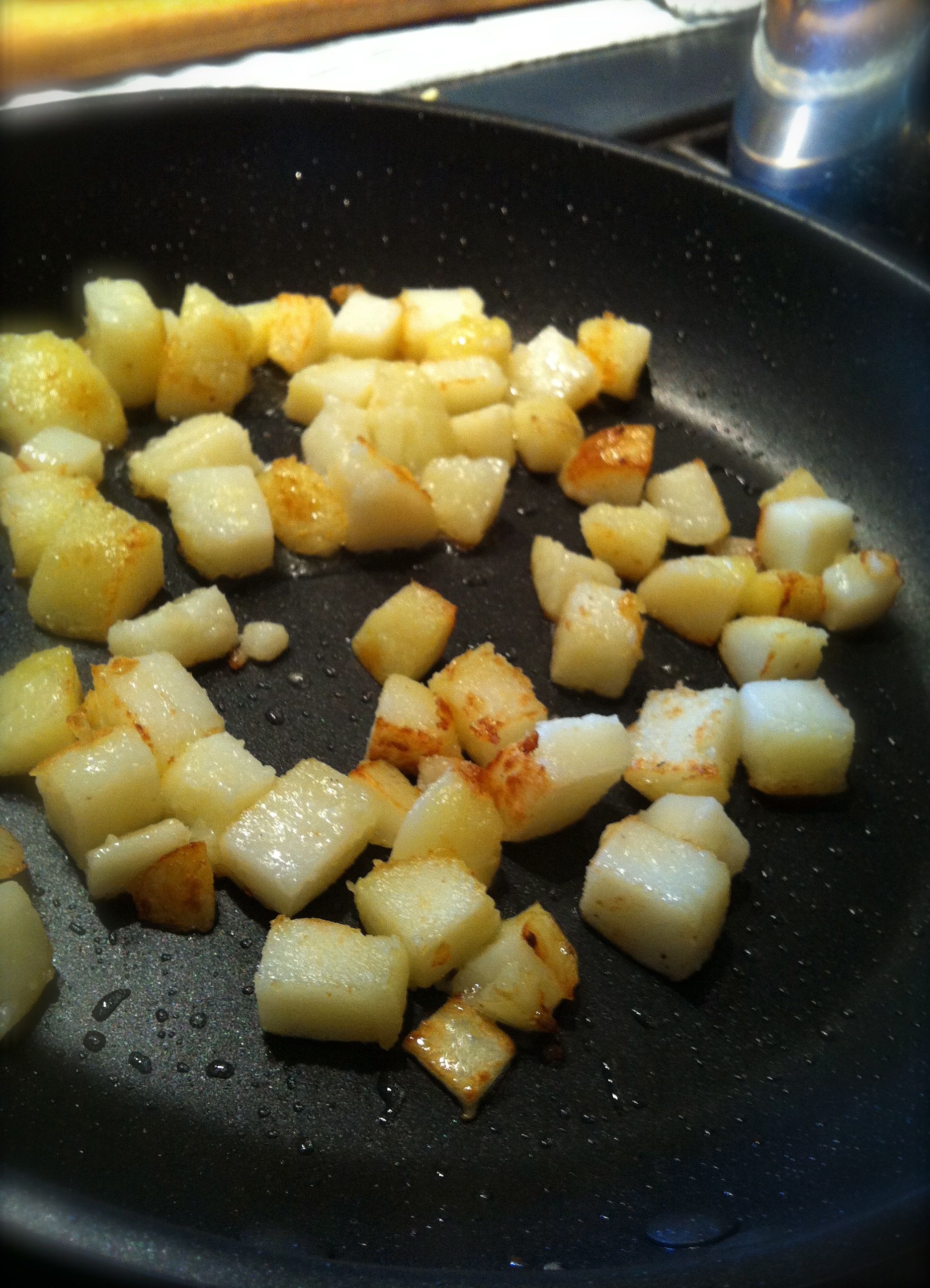 Texas Mexican Potataoes start with cooking the potatoes in a little vegetable oil until they get crispy.
